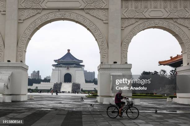 Bike rides past the Chiang Kai-shek Memorial Hall on Liberty Square as daily life continues ahead of general election in Taipei, Taiwan on January 9,...