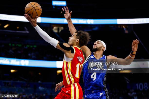 Trae Young of the Atlanta Hawks shoots the ball against Jalen Suggs of the Orlando Magic during the first half of a game at the Kia Center on January...