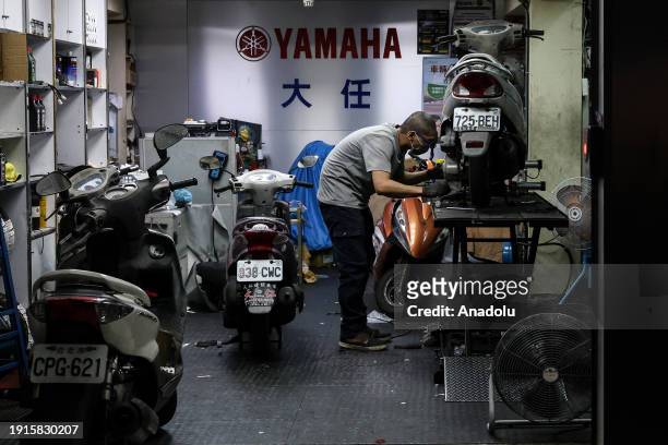 Mechanic repairs a motorbike as daily life continues ahead of general election in Taipei, Taiwan on January 9, 2024. Voters will elect Taiwan's next...