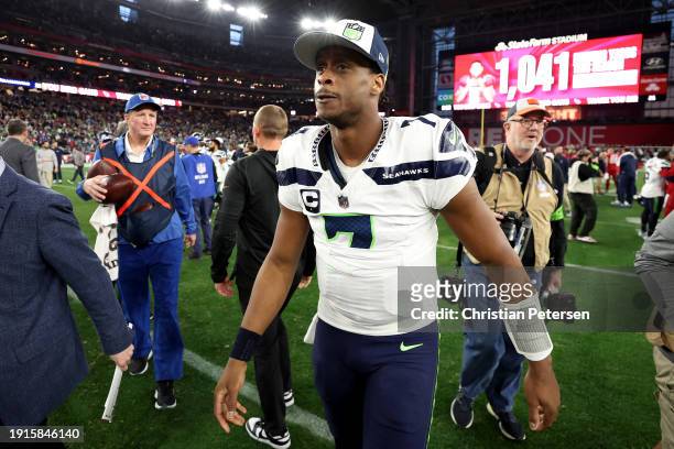 Geno Smith of the Seattle Seahawks walks off the field after the game against the Arizona Cardinals at State Farm Stadium on January 07, 2024 in...