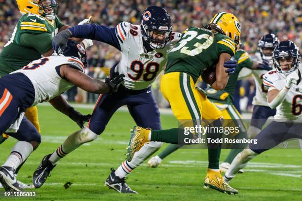 Defensive End Montez Sweat of the Chicago Bears pursues Running Back Aaron Jones of the Green Bay Packers during the second half of an NFL football...