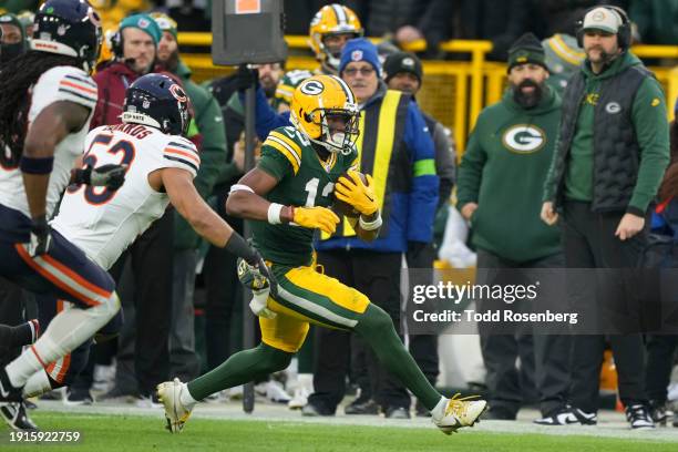 Wide Receiver Dontayvion Wicks of the Green Bay Packers runs the ball during an NFL football game against the Chicago Bears at Lambeau Field on...