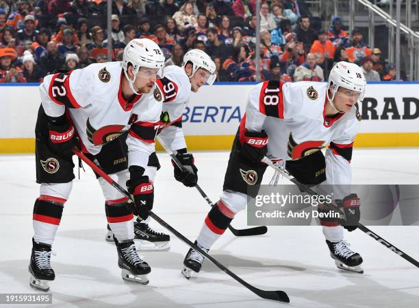 Thomas Chabot, Vladimir Tarasenko, and Tim Stützle of the Ottawa Senators await a face-off during the game against the Edmonton Oilers at Rogers...