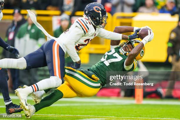 Wide Receiver Romeo Doubs of the Green Bay Packers attempts to pull in a pass during the first half of an NFL football game at Lambeau Field on...