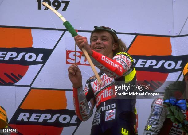 Valentino Rossi of Italy celebrates victory at the British Motorcycle Grand Prix at Donington Park in England. Rossi went on to win the 125cc world...