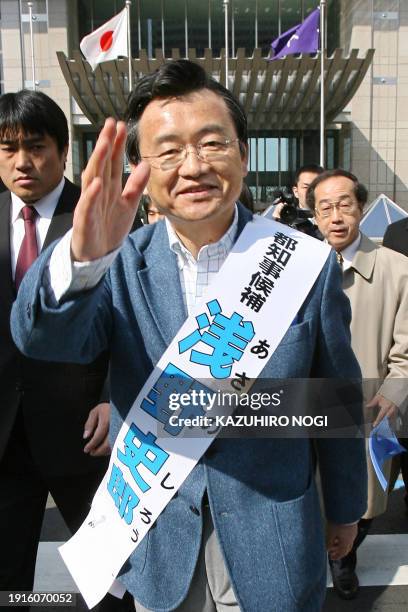 Former Miyagi Prefectural Governor Shiro Asano, a candidate for Tokyo governor polls waves to supporters during his election campaign in front of the...