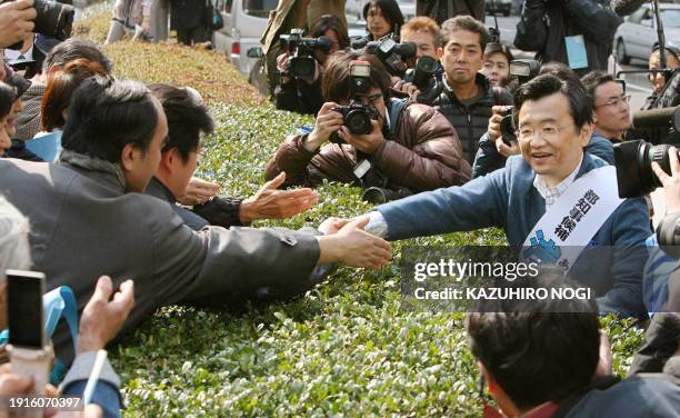 Former Miyagi Prefectural Governor Shiro Asano , a candidate for Tokyo governor polls, shakes hands with supporters during his election campaign in...