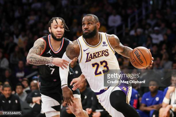 LeBron James of the Los Angeles Lakers drives to the basket against Amir Coffey of the Los Angeles Clippers in the second quarter at Crypto.com Arena...
