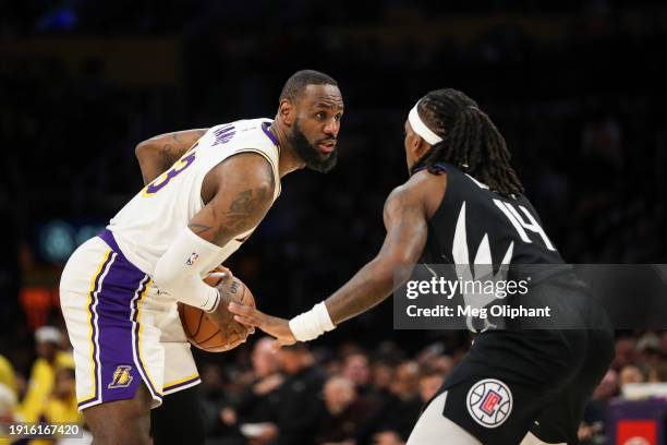 LeBron James of the Los Angeles Lakers handles the ball against Terance Mann of the LA Clippers in the second quarter at Crypto.com Arena on January...