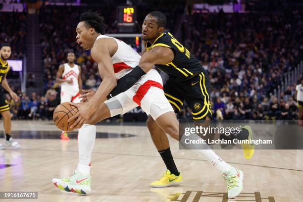 Jonathan Kuminga of the Golden State Warriors steals the ball away from Scottie Barnes of the Toronto Raptors in the third quarter at Chase Center on...