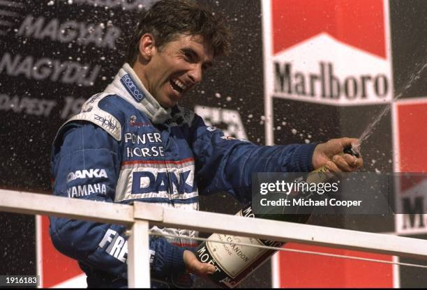 Arrows-Yamaha driver, Damon Hill of Great Britain sprays the champagne on the podium after the Hungarian Grand Prix at Hungaroring in Hungary. Hill...