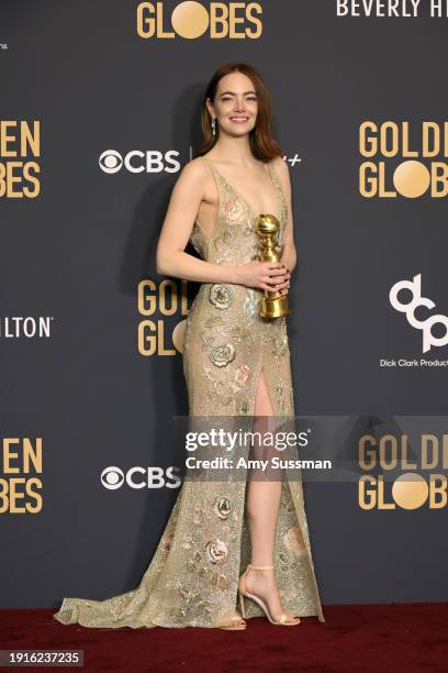 Emma Stone, winner of the Best Performance by an Actress in a Motion Picture, Musical or Comedy award for "Poor Things" poses in the press room...