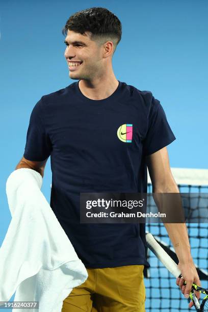 Carlos Alcaraz of Spain smiles during a training session ahead of the 2024 Australian Open at Melbourne Park on January 08, 2024 in Melbourne,...