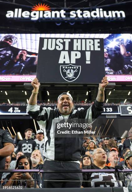 Las Vegas Raiders fan "Vegas" Ralph Sotelo of Nevada holds a sign supporting interim head coach Antonio Pierce, using his nickname "AP," as head...