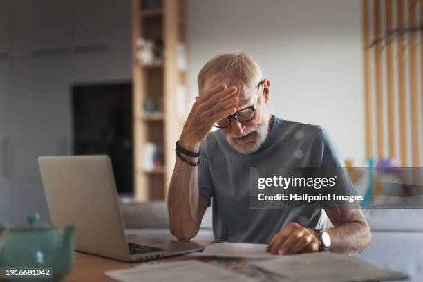 senior man reading touching letter from friend, notification about increased healthcare costs, bad medical test results, hight utility bill. elderly man feeling anxious, sad and sentiment. - broma pesada fotografías e imágenes de stock
