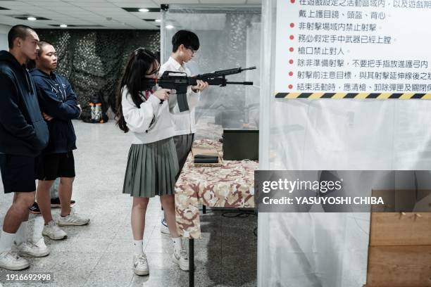 Students learn how to use airsoft rifles at Kaohsiung Municipal Sanmin Senior High School in Kaohsiung on January 11, 2024. Kaohsiung City launched a...