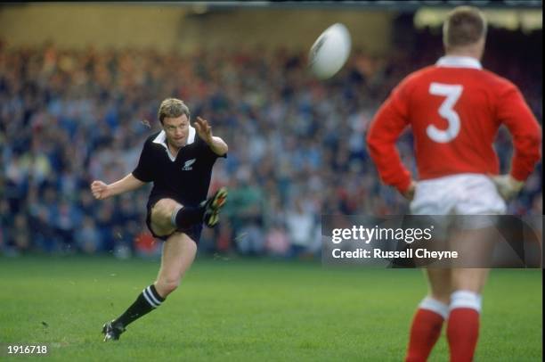 Grant Fox of New Zealand kicks the ball over the Welsh during the All Blacks tour of Britain match between Wales and New Zealand at Cardiff Arms Park...