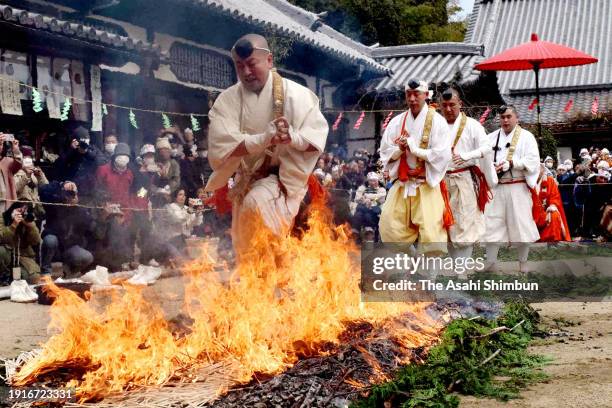 Buddhism practitioner walks on the fire during the Hiwatari ritual at Saikokuji Temple on January 8, 2024 in Onomichi, Hiroshima, Japan. People...