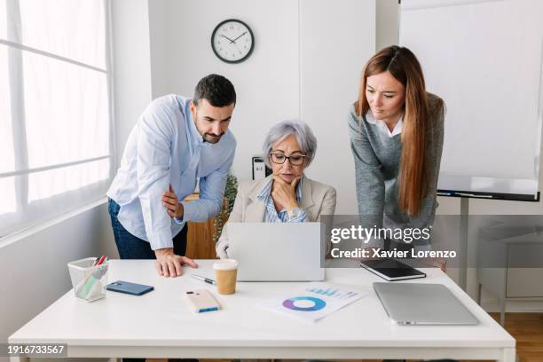 diverse group of business people discussing at desk - image technique stock pictures, royalty-free photos & images