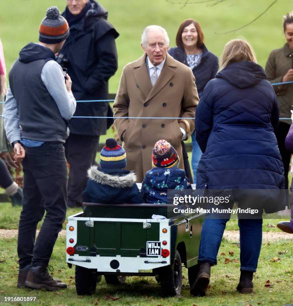 King Charles III talks with Simon Ward, Georgina Ward and their sons William and Oliver, who are driving their toy replica Land Rover, as he attends...