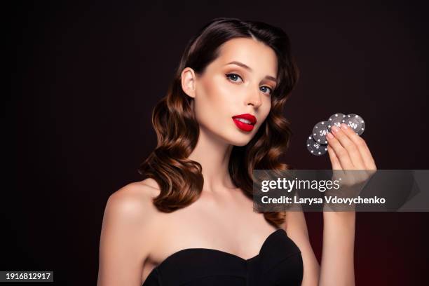 photo of classy cunning lady professional poker cheater holding chips over dark color background - cheater stock pictures, royalty-free photos & images