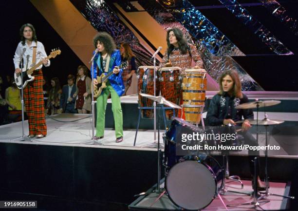 English rock band T Rex perform on the set of a pop music television show in London circa 1970. Members of the group are, from left, Steve Currie ,...