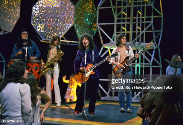 English rock band T Rex perform on the set of a pop music television show in London in February 1971. Members of the group are, from left,...