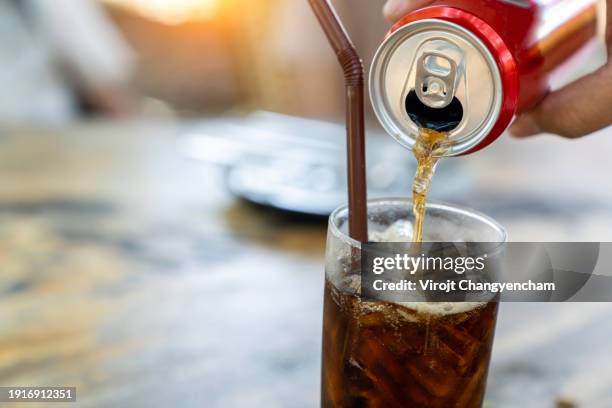 filling soft drink into a glass. - gassata foto e immagini stock