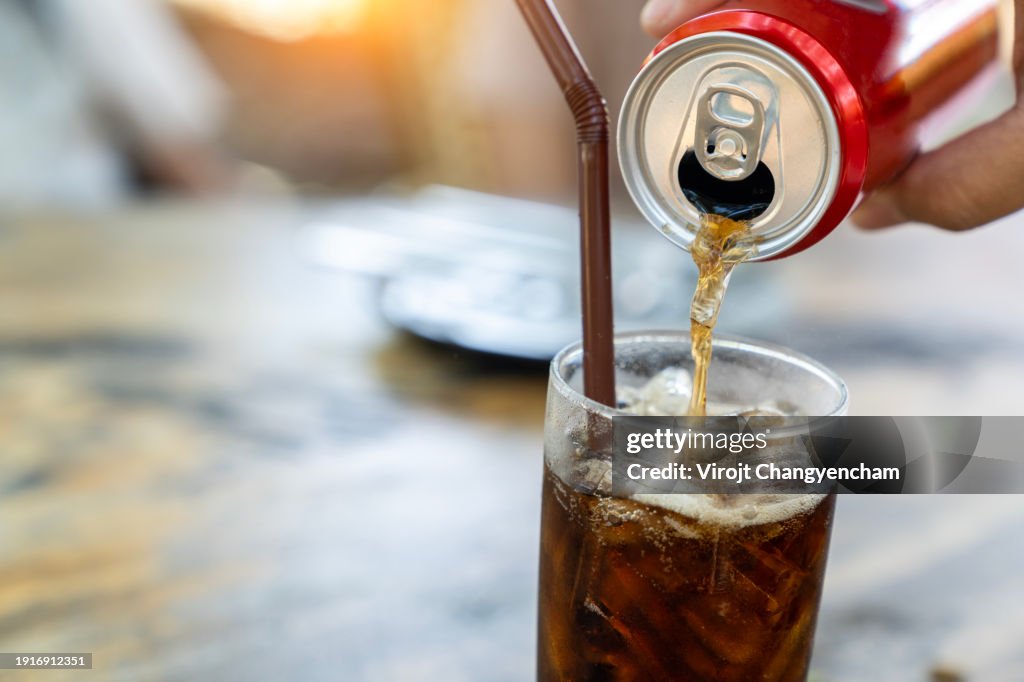 Filling soft drink into a glass.