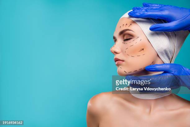photo of attractive lady prepare for plastic surgery examine by cosmetologist touch face hands over cyan background - rinoplastica foto e immagini stock