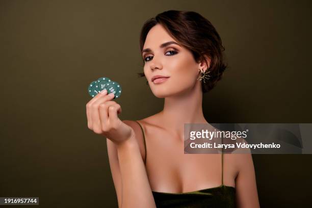 photo of rich attractive chic girl in velvet stylish evening gown holding casino chips over green color background - casino worker stock pictures, royalty-free photos & images
