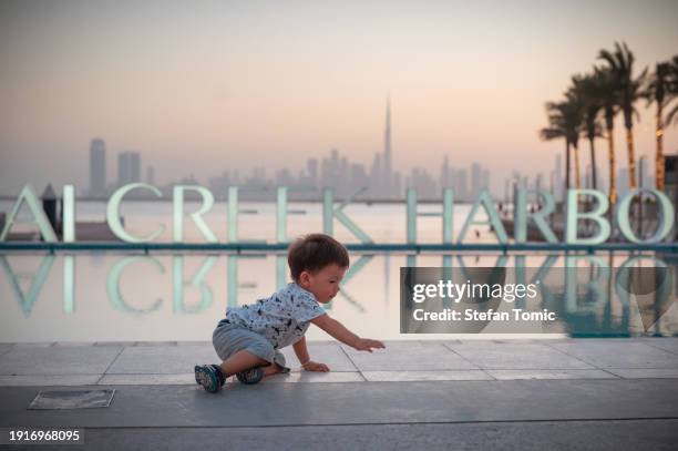 adorable baby's dubai creek harbor adventure - dubai creek stock pictures, royalty-free photos & images