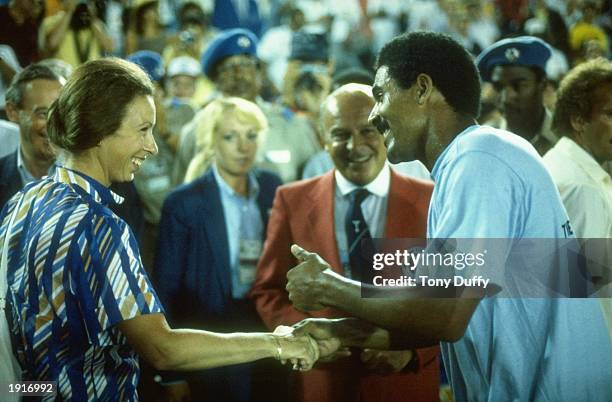 Her Royal Highness Princess Anne greets and jokes with Daley Thompson of Great Britain as he celebrates his gold medal victory in the Men's Decathlon...