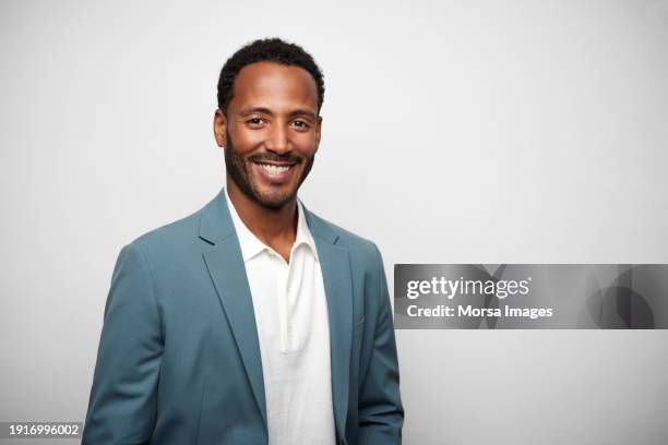african american young businessman against white background - uomini foto e immagini stock