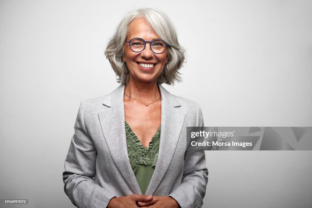 Happy Senior Woman Against White Background