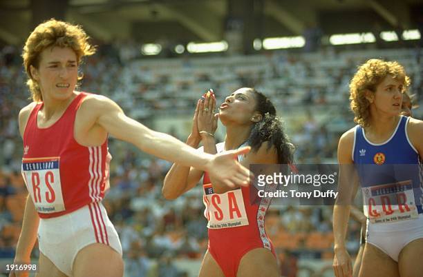 Olga Bryzgina of the Soviet Union waits impatiently and Florence Griffith-Joyner of the USA prays as they get ready to run the last leg of the 4x400...