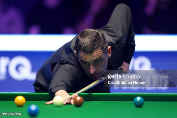 Ronnie O'Sullivan of England plays a shot in his first round match against Ding Junhui of People's Republic of China during day two of the MrQ...