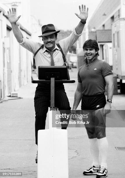 Actor Stacy Keach with fitness trainer Dan Issacson on Warner Bros studio lot, November 9, 1983 in Burbank, California.