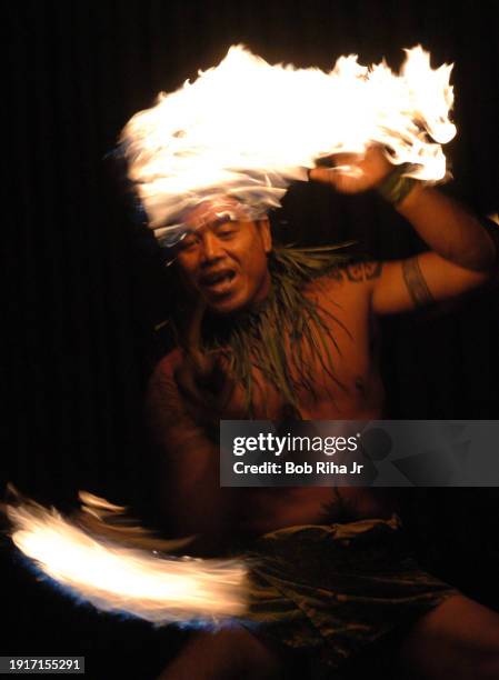 Hawaiian Fire Knife Dancer also known as Fire Twirler performs for guests at a luau, December 21, 2005 in Honolulu, Hawaii.