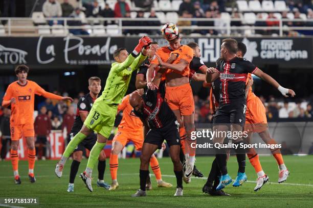 Roman Yaremchuk Centre-Forward of Valencia CF competes for the ball with Mikel Rico of FC Cartagena during the Copa del Rey Round of 32 match between...