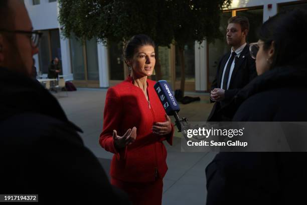 German far-left politician Sahra Wagenknecht speaks to a reporter after she and colleagues announced the official launch of their new political party...