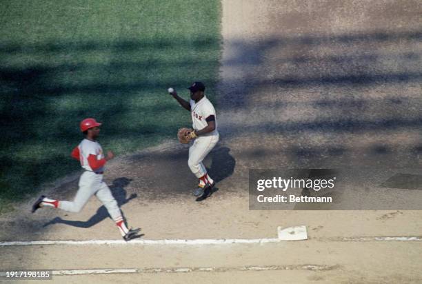 Curt Flood of St Louis Cardinals is out at first as George Scott makes the catch in first inning of sixth World Series game, October 11th 1967.