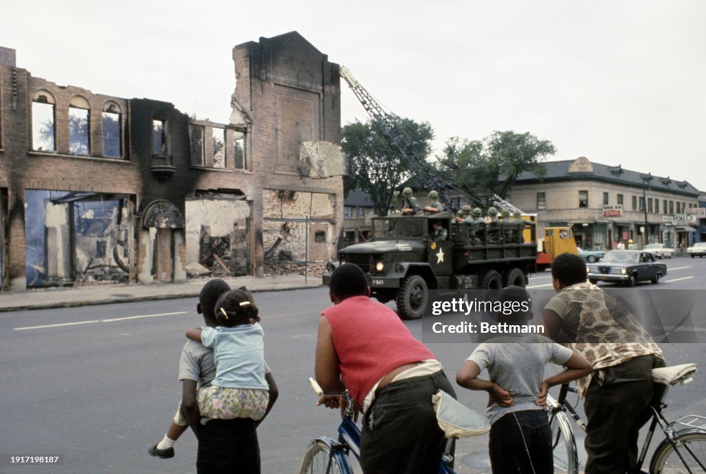Detroit 75 Riots A group of children watch as workmen knock down a building gutted by ...