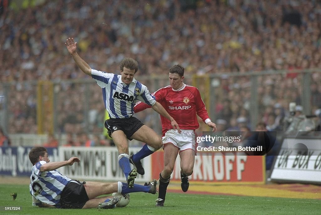 Roland Nilsson and Nigel Pearson of Sheffield Wednesday and Lee Sharpe of Manchester United
