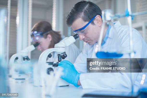 in the cutting-edge laboratory, scientists conducted a groundbreaking experiment involving the precise manipulation of various chemicals and experimental substances, all while clad in specialized grounding suits. this innovative endeavor aimed to advance - conducted stock pictures, royalty-free photos & images