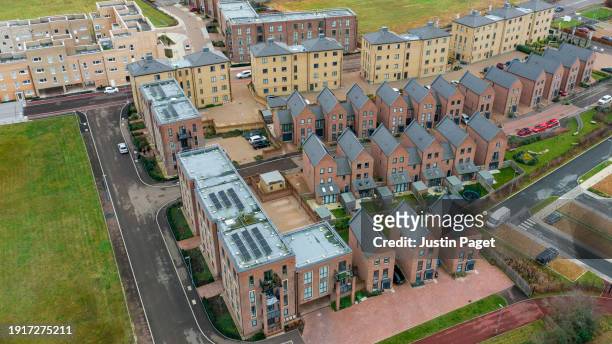 aerial view of a new residential district in the uk. there are many solar panels on the roof - sustainable development - cambridge uk aerial stock pictures, royalty-free photos & images