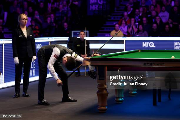 Ding Junhui of People's Republic of China reacts after getting a maximum break of 147 points in his first round match against Ronnie O'Sullivan of...