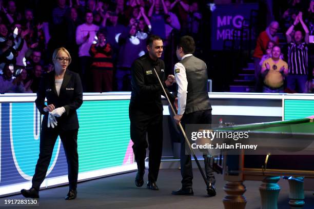 Ding Junhui of People's Republic of China is congratulated by opponent Ronnie O'Sullivan of England after getting a maximum break of 147 points in...