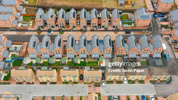 aerial view of a new residential district in the uk. there are many solar panels on the roof - sustainable development - cambridge uk aerial stock pictures, royalty-free photos & images