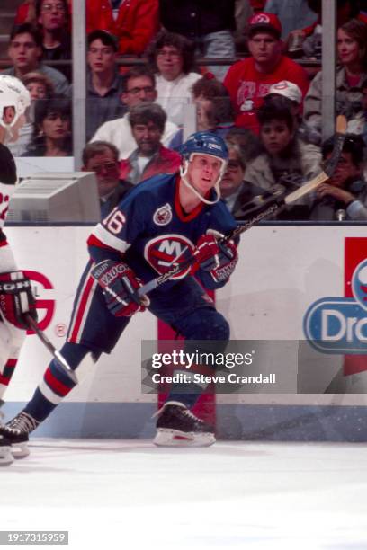 New York Islander's forward, Brian Mullen, dumps the puck into the Devil's zone during the game against the NJ Devils at the Meadowlands Arena ,East...